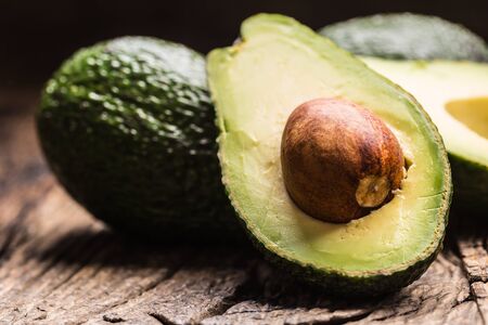 Fresh avocado on rustic wooden table - Close up.
