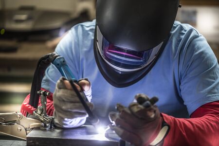 Welder industrial worker welding with argon machine.の写真素材