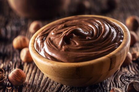 Chocolate hazelnut spread in wooden bowl - Close up.の写真素材