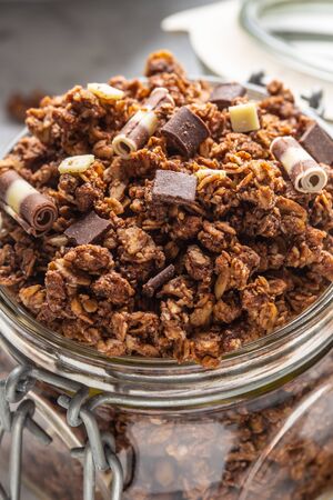 Jar of muesli with dark and milk cocolate pieces - closeup.の写真素材