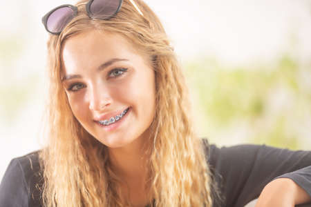 Happy smiling teen girl with dental braces.