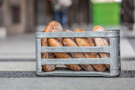 Box with a freshly baked bread delivered in front of the store.の写真素材