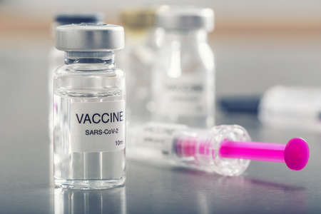 Covid-19 coronavirus vaccine in a ampoule with syringe ready for vaccination.
