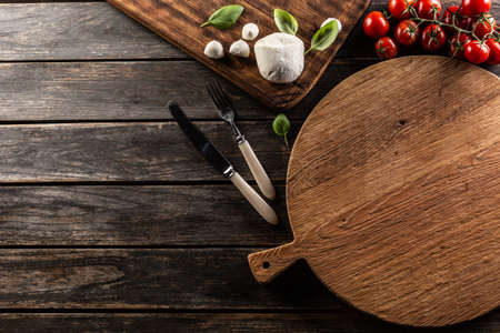 Empty pizza round tomatoes mozzarella cheese and basil - top of view copy space.の写真素材