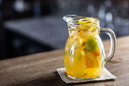 Fresh lemonade with various citruses in a full jar with fresh wedges of fruit inside.