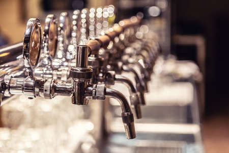 Broad variety of draft beer pipes in a pub ready for serving beer.の写真素材