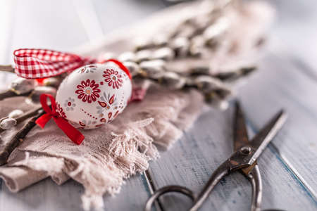 Handmade easter eggs with willow catkins on a linen napkin.の写真素材