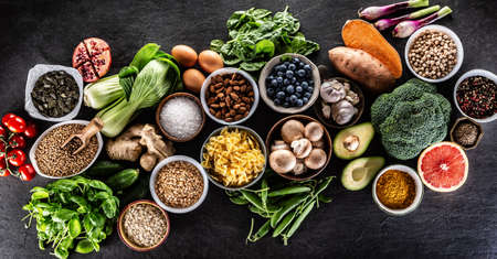 Choice of fresh food and healthy eating:vegetables, fruits, legumes and cereals on a concrete table...