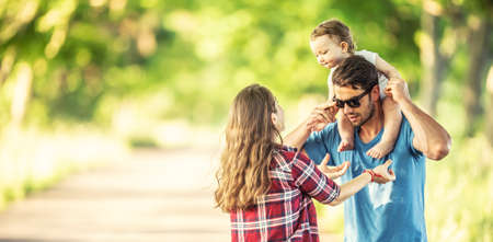 Young parents with daughter enjoying moments together in the park.の写真素材