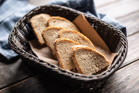 Slices of bread served in a basket in a rustic environment.の写真素材