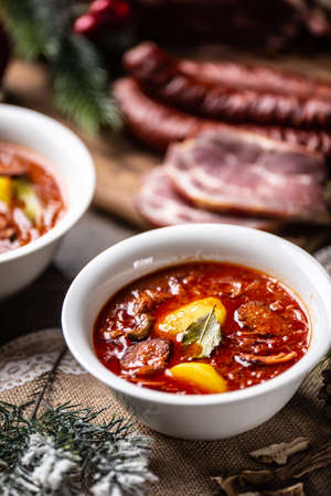 Traditional christmas sour cabbage soup with potatoes, sausage, smoked pork and mushrooms.