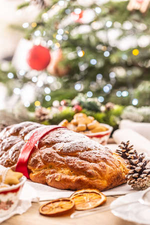 Traditional Czech Christmas cake Vanocka on a festive table in front of a Christmas tree.の写真素材
