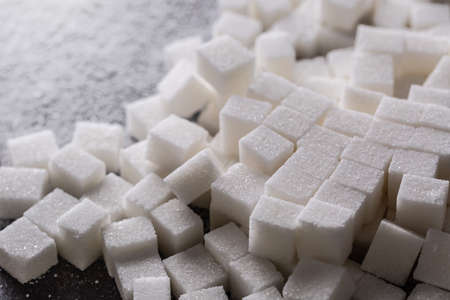 White sugar cubes sprinkled on the kitchen table.