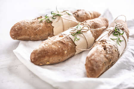 Soft and crunchy baguettes from wholgrain flour on a white background.