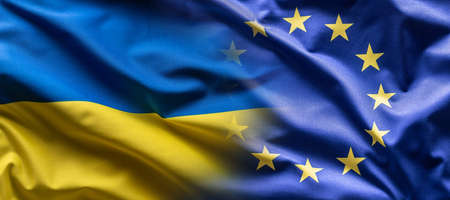 Ukrainian and the EU flag blending into each other as European Union leans towards the membership of...