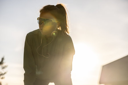 A young athlete concentrates on running at sunrise or sunset.の写真素材