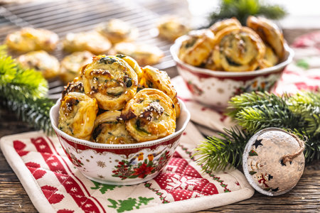 Christmas savory pastries, mini pizza cakes in a typical Christmas dish and festive decorations.の写真素材