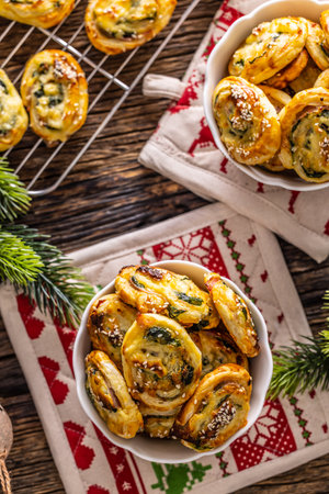 Christmas savory pastries, mini pizza cakes in a typical Christmas dish and festive decorations.の写真素材