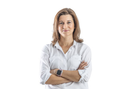 Portrait of confident businesswoman with crossed arms on isolated white background.の写真素材