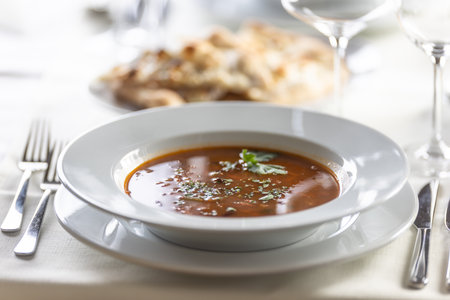 Plate of Italian minestrone soup with a fancy serving in a restaurant.