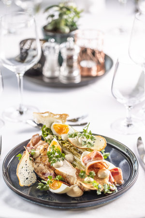 Restaurants serves chicken breasts a la ceasar salad as a variation of an appetizing meal.の写真素材