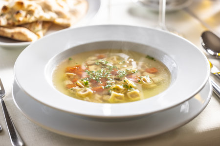 Chicken or rooster stock soup with tortellini.の写真素材