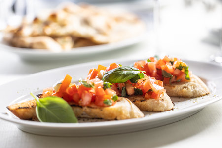 Bruschetta with tomatos and basil served on a crunchy bread.の写真素材