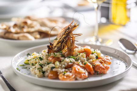 Schrimp and courgette risotto Italian style with a decorative tiger prawn on top.の写真素材