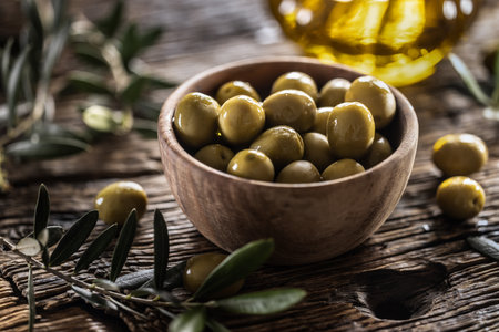 Green olives from mediterranean are served in wooden bowl.の写真素材