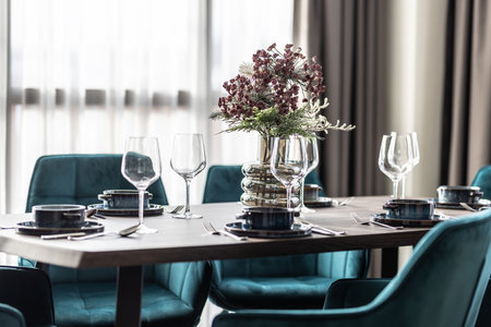 Dining room with wooden table and blue chairs floor in modern apartment. Modern setting in the...