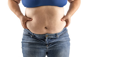 Plus size overweight woman holds her hips full of fat - Isolated on white.の写真素材