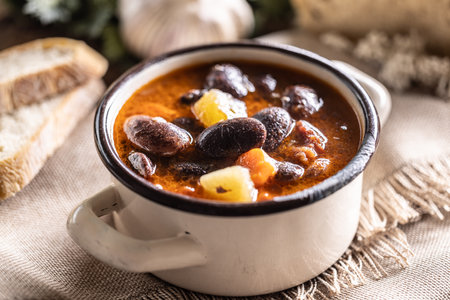 Traditional bean soup made from big beans, smoked neck, potatoes, and carrots.の写真素材