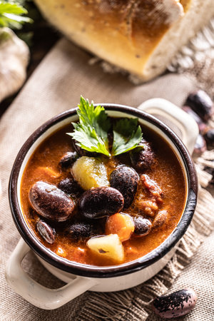 Traditional bean soup made from big beans, smoked neck, potatoes, and carrots.の写真素材