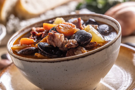 Traditional bean soup made from big beans, smoked neck, potatoes, and carrots.の写真素材