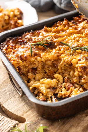 Baked pasta with smoked meat, sausage, egg, cheese and spices. Traditional Czech food.の写真素材