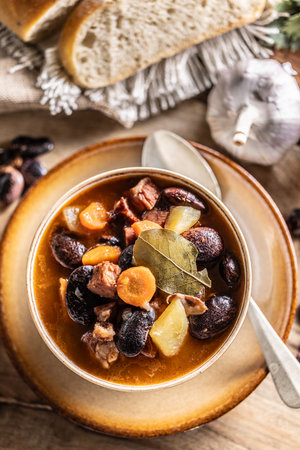 Traditional bean soup made from big beans, smoked neck, potatoes, and carrots.の写真素材