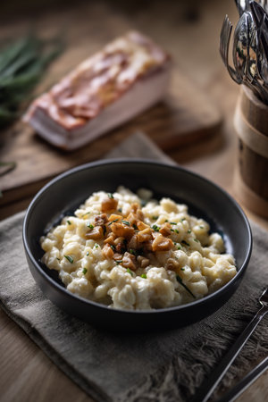 Halusky as traditional Slovak potato gnocchi with sheep cheese bryndza, fried bacon and chives.の写真素材