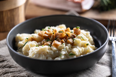 Halusky as traditional Slovak potato gnocchi with sheep cheese bryndza, fried bacon and chives.の写真素材
