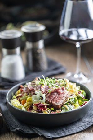 Fillet of beef sirloin with lettuce salad in plate on pub or restaurant.の写真素材