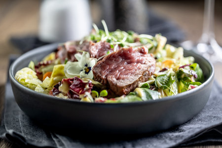 Fillet of beef sirloin with lettuce salad in plate on pub or restaurant.の写真素材