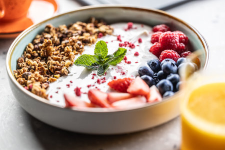 A bowl full of berries, yogurt and cereal. Healthy breakfast concept.の写真素材