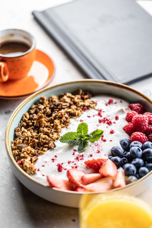 A bowl full of berries, yogurt and cereal. Healthy breakfast concept.の写真素材