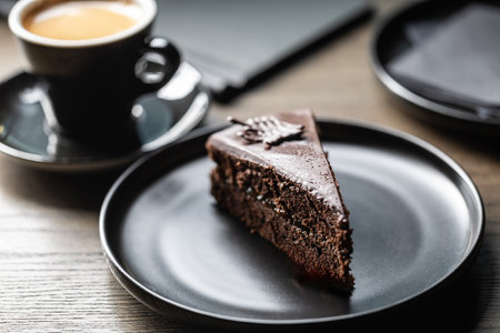 Sacher cake with coffee on the table in the cafe.の写真素材