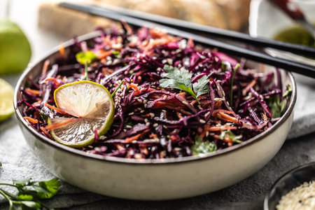 Asian red cabbage and carrot salad seasoned with coriander and sesame.の写真素材