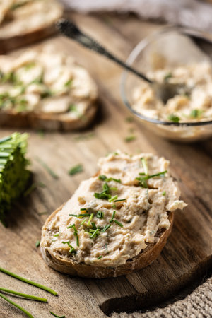 Close-up of bread slice with traditional Slovak bryndza spread made of sheep cheese with freshly cut...