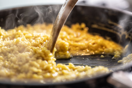 Preparation of saffron risotto in a pan on a gas stove.の写真素材