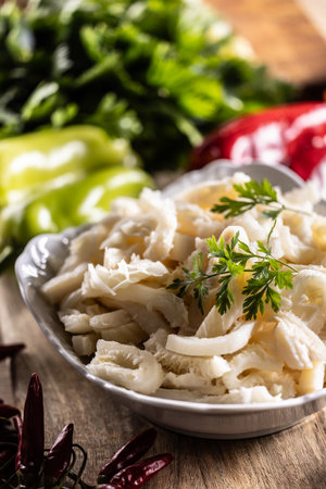 Precooked beef tripes in a bowl with vegetables and herbs ready for cooking.の写真素材
