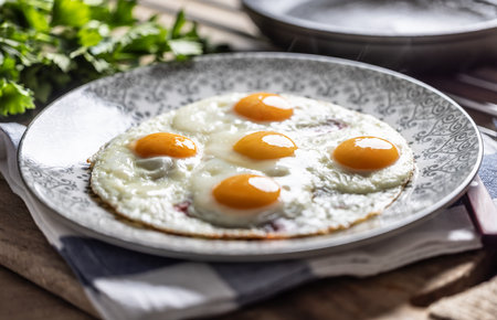 English breakfast on a plate. Ham and eggs sprinkled with parsley.の写真素材