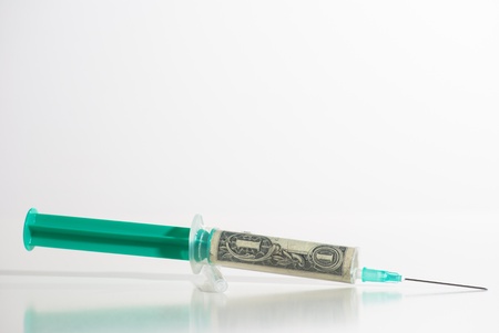 Syringe and money on white backgroundの写真素材