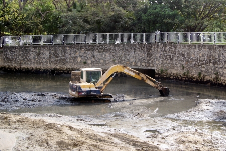 The excavator working in the river 